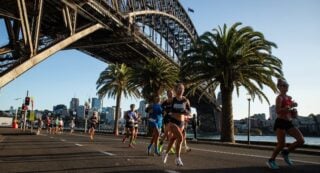 Runners in a marathon passing under the Sydney Harbour Bridge